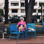 Taken in Cannes, France 2015. I took this photograph on Promenade de la Croisette, during my summer holiday. Whilst everyone is mostly new wealth, this woman stood out, as she is relatively modest in appearance, and accompanied by a dog, as well as being elderly. I found it amusing how the dog shared the same facial expression as the dog.