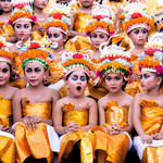 Image was taken in Bali during Melasti Festival. This Festival is conducted once a year in conjunction with Nyepi or Silent Day. These young girls were waiting for their turn to perform. They looked stunning with their bright coloured costumes and heavy make-up on, however the expression on each of the girls' face especially the yawning girl gives this image an extra 'ummpph'.